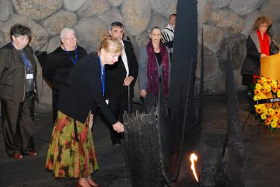 Ms. Stephanie Seltzer, President of the WFJCSH, rekindling the eternal flame in the Hall of Remembrance.